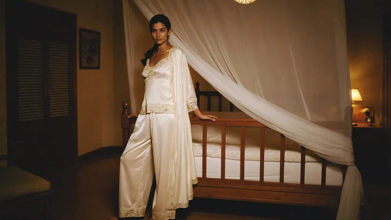 The set completer, the same robe and pyjamas beside the canopy bed, lamp lit